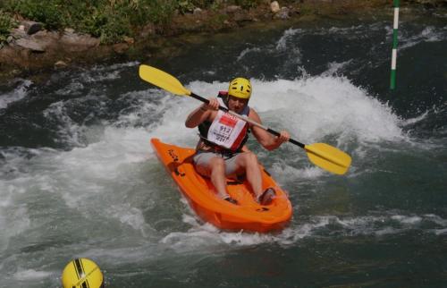 un homme dans un kayak orange dans une rivière dans l'établissement Odeon B near Basel, à Huningue