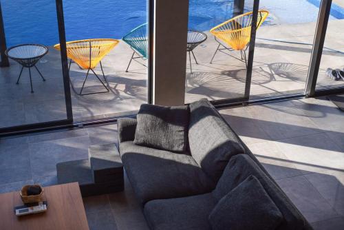 a living room with a couch and a table and chairs at Gold Valley Villa A in Futtsu