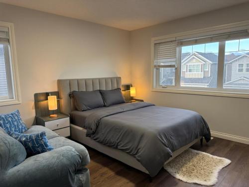 a bedroom with a bed and a couch at Exquisite Entire 4- Bed rooms vacation home! in Calgary