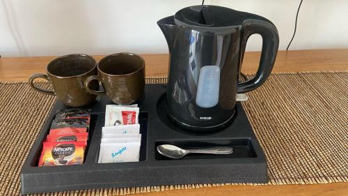 a black tray with a blender and two cups at Santai Suites Nusa Dua in Nusa Dua