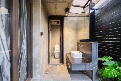 a bathroom with a sink and a toilet at Luxury Modern Pool Jacuzzi Villa 5BR Thonglor in Khlong Toei
