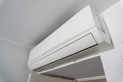 a white microwave oven hanging from a ceiling at Apart Hotel Petit Palace Suites in Lima