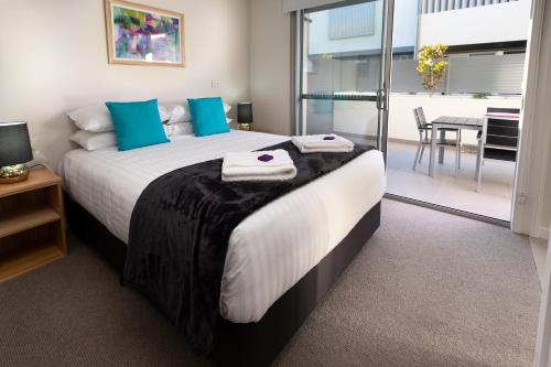 Ένα ή περισσότερα κρεβάτια σε δωμάτιο στο Hamilton Executive Apartments