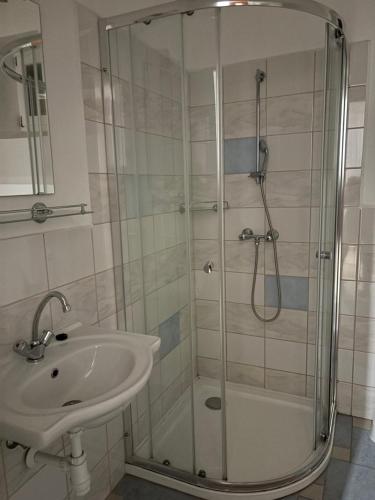 a bathroom with a shower and a sink at The Blue in Csátalja