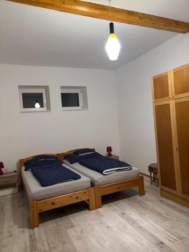 a bedroom with a bed with pillows on it at The Blue in Csátalja