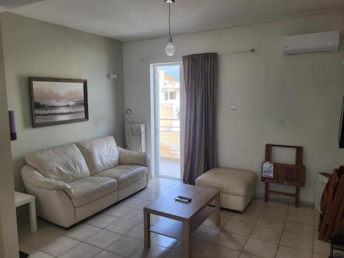 a living room with a couch and a table at Kalamata Apartment Beach Front in Kalamata