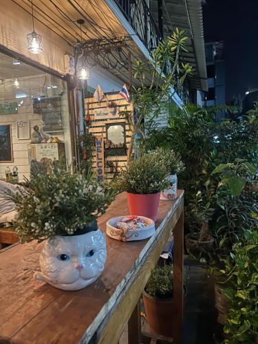 a table with potted plants on top of it at La Locanda in Bangkok