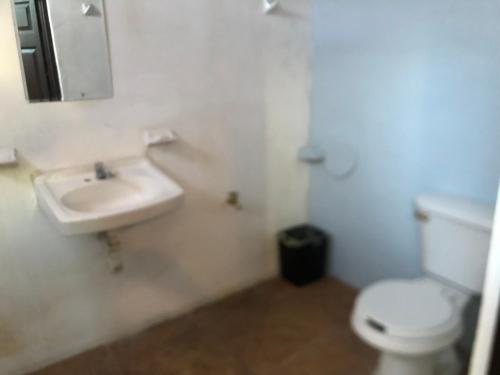a bathroom with a white toilet and a sink at Departamento zona centro in Ticul