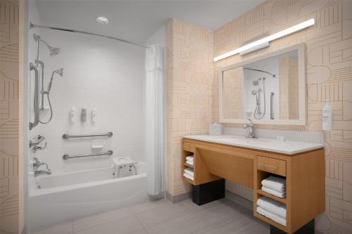 a bathroom with a sink and a tub and a shower at Home2 Suites by Hilton Sioux Falls Sanford Medical Center in Sioux Falls