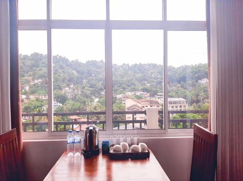 a table in a room with a large window at Terrace Kandy in Kandy