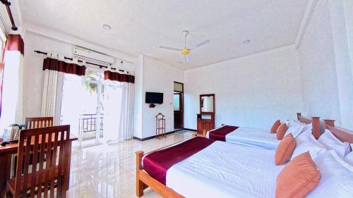 a bedroom with a large bed and a large window at Terrace Kandy in Kandy