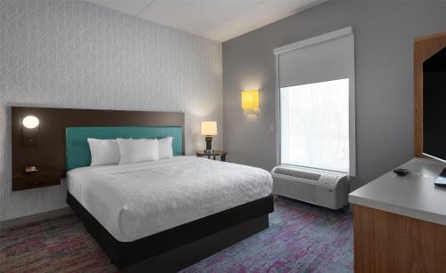 a hotel room with a bed and a window at Home2 Suites by Hilton Greenville Airport in Greenville