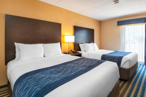 a hotel room with two beds and a window at Comfort Inn in Saint Thomas