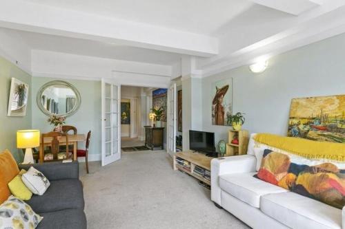 a living room with a bed and a couch at Historical 2 beds apartment with Harbour Views in OBay in Wellington
