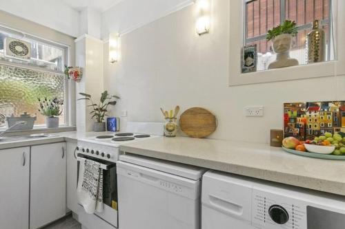 a kitchen with white appliances and a counter top at Historical 2 beds apartment with Harbour Views in OBay in Wellington