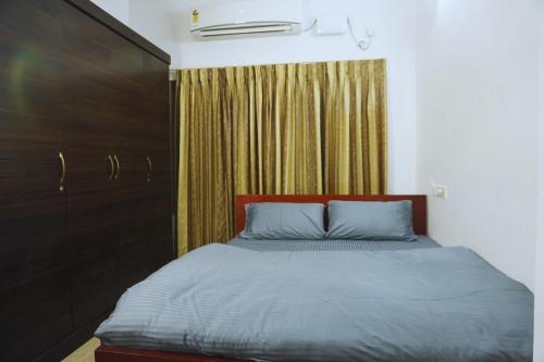 a bedroom with a bed and a dresser in it at 4BHK Independent Garden Villa, heart of the city in Trivandrum