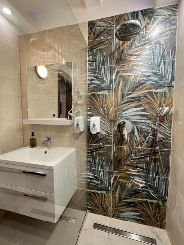 a bathroom with a sink and a mirror at ElDorado apartman in Zalaegerszeg