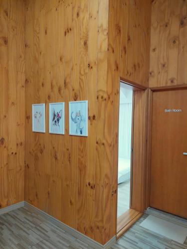 a room with wooden walls with four pictures on the wall at 지금이순간 in Busan