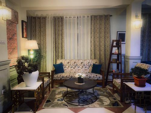 a living room with a couch and a table at The Sherpas Rest in Darjeeling