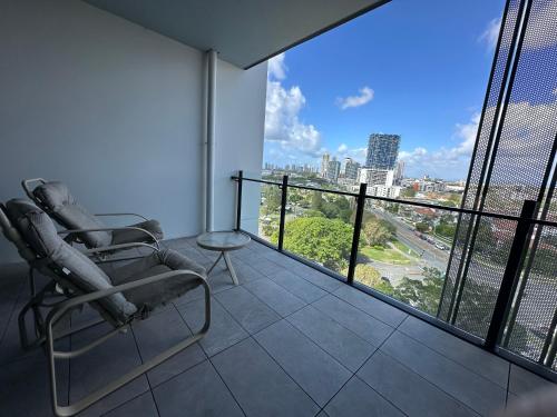 a balcony with a chair and a view of a city at Cityscape Serenity at Southport in Gold Coast