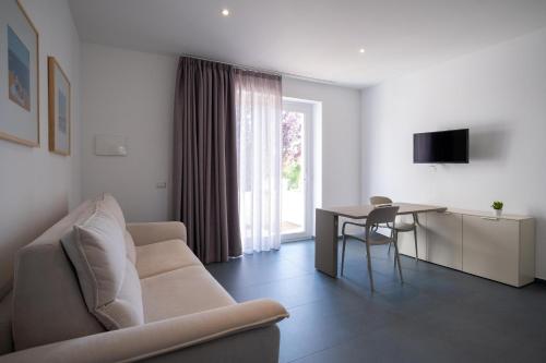 a living room with a couch and a table at Nautika Suites in Alghero
