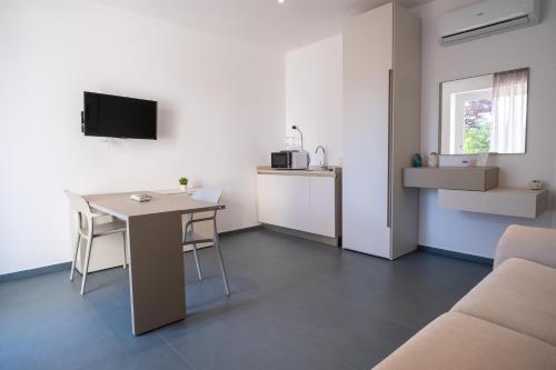 a living room with a table and a couch at Nautika Suites in Alghero