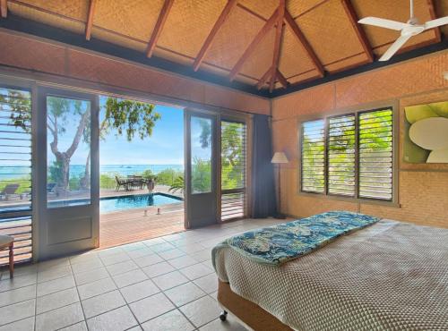 a bedroom with a bed and a view of a pool at Absolute Beachfront and Pool House in Horseshoe Bay