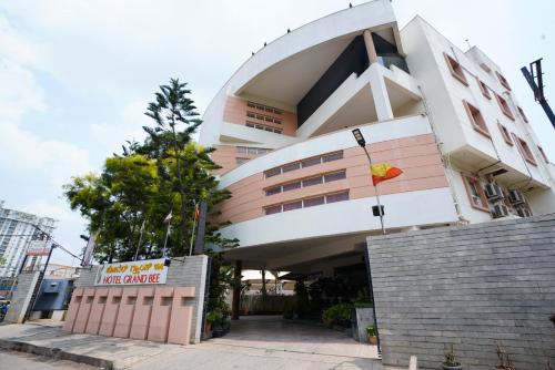 a building with a sign in front of it at Hotel Grand Bee , Yeshwanthpur Junction in Bengaluru