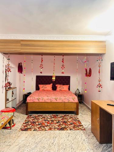 a bedroom with a bed with red sheets and red decorations at Phulkari Hospitality Dhanbad in Dhanbād