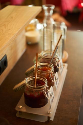 a row of jars of jam on a table at Hotel Jägerhof in Oetz
