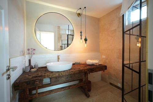 a bathroom with a sink and a mirror at Appartement Am-Wildpfad in Bad Goisern