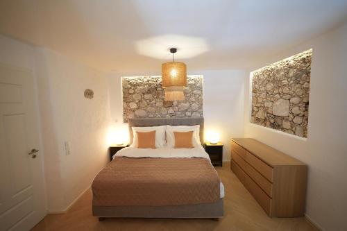 a bedroom with a bed and two paintings on the wall at Appartement Am-Wildpfad in Bad Goisern