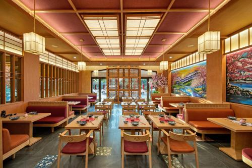 a restaurant with tables and chairs in a room at Sakurakyo Hotel & Spa Phu Quoc - Free Hon Thom Island Waterpark Cable Car Until 15 December 2025 in Phu Quoc