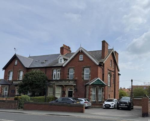 a large brick house with cars parked in front of it at Elford House - Whitby in Whitby