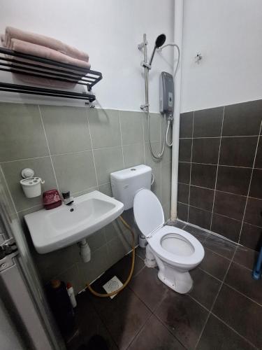 a bathroom with a toilet and a sink at TheRapy House in Malacca