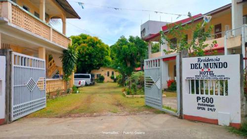 a gate to a building with a sign on it at Residencia del Mundo - Hotel in Puerto Galera