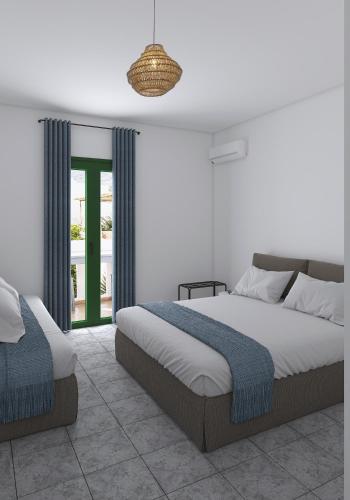 a bedroom with a large bed and a window at Eleios Hotel Serifos in Livadi