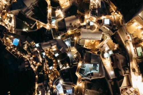 an aerial view of a city at night at Nano Oia Villas in Oia