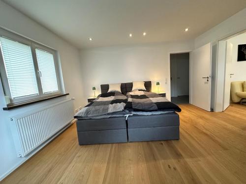 a bedroom with a bed and a large window at Apartment um Herzen von Echterdingen in Leinfelden-Echterdingen