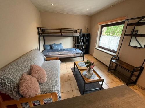 a living room with a couch and a bunk bed at Eleni in Bad Bramstedt