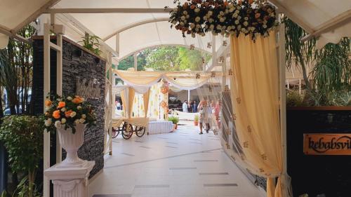 an aisle with curtains and flowers in a building at Enrise by Sayaji Bhopal in Bhopal