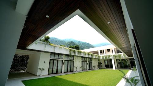 a view of a building with a green yard at Phool Chatti Yoga Ashram 7 day Yoga Retreat in Shivpuri