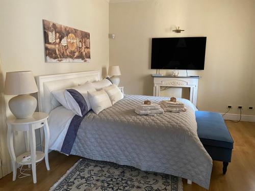 a bedroom with a bed with two towels on it at Stanze Degli Aceri in Murazzano