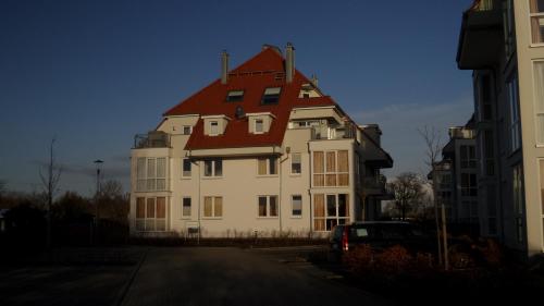 a large white building with a red roof at Apartment Seestern in Großenbrode