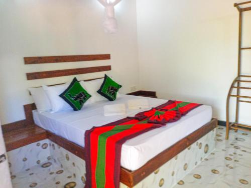 a bedroom with a bed with a christmas bow on it at Sigiriya Moon Mirage Villa in Sigiriya