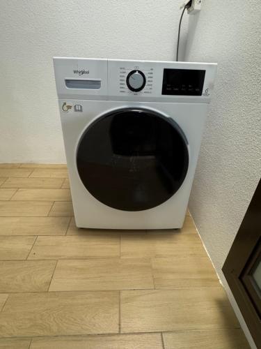 a white microwave oven sitting on a wooden floor at 隱 Villa 旅宿 in Chaozhou