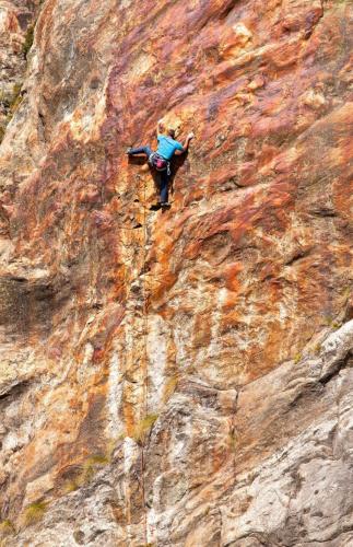 a person is climbing on a rocky mountain at Walliser Stadel in Fieschertal