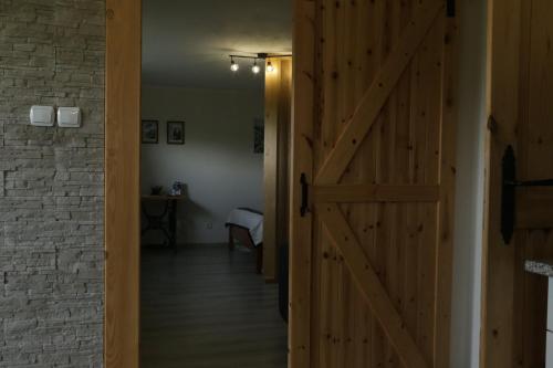 a door leading into a room with a hallway at Apartament w ogrodzie in Tylka
