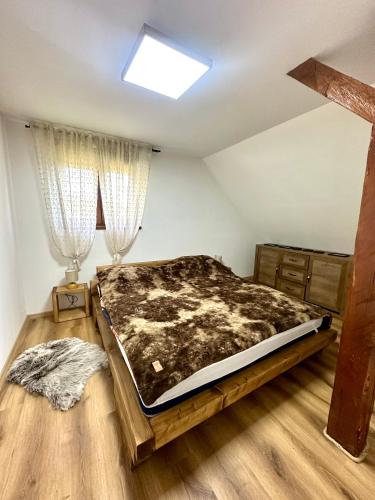 a bedroom with a large bed in a room at Apartman Bajt in Ravna Gora