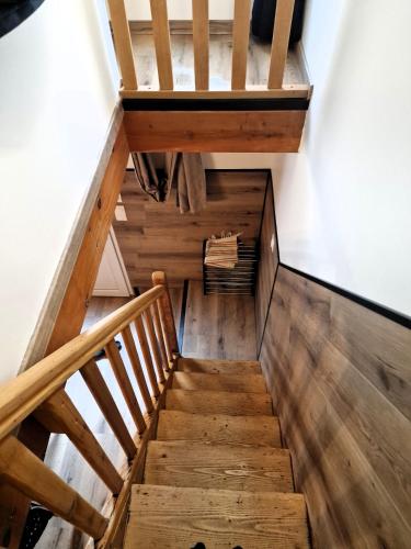 a staircase with wooden floors and a wooden railing at Hotel La Reserve in Vic-la-Gardiole